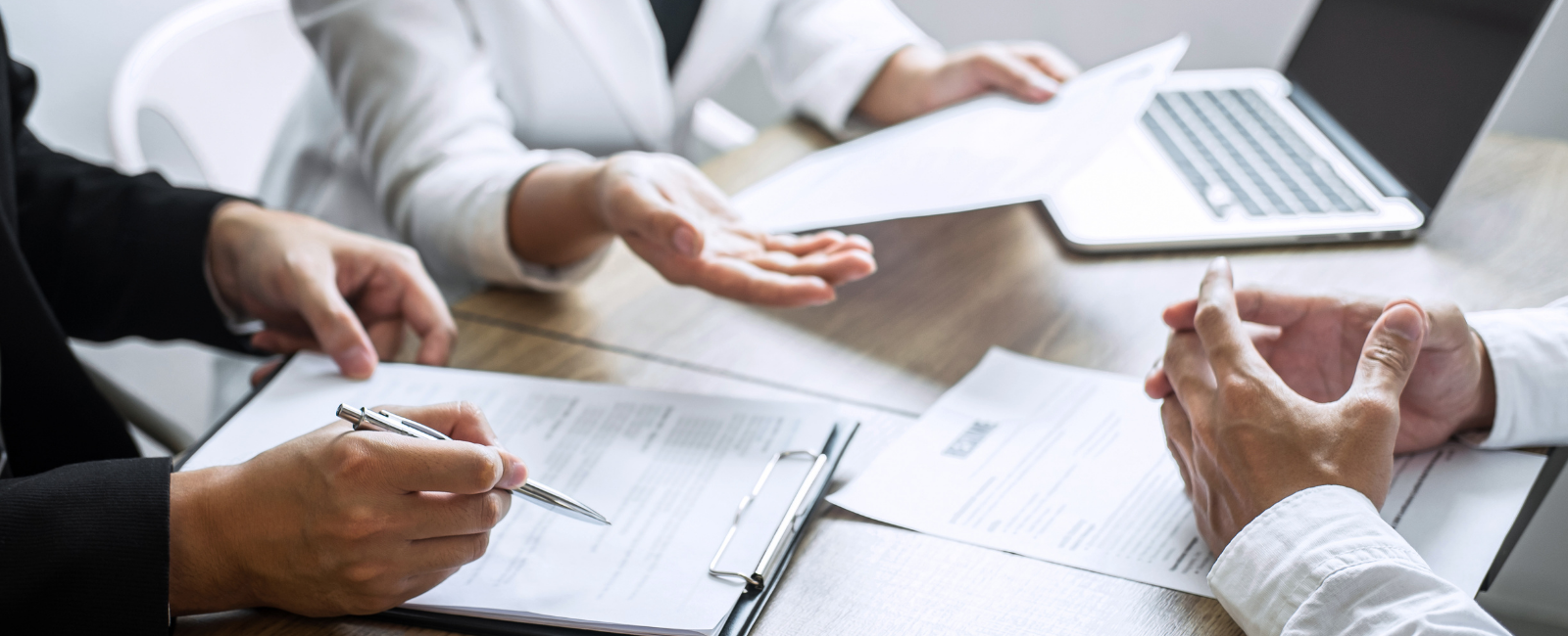 three people looking through paperwork